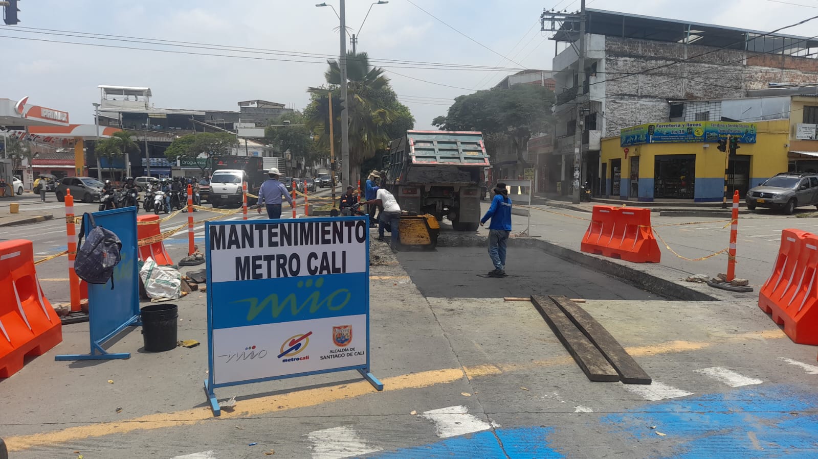 Foto en la cual se ve una volqueta y personas trabajando en el carril exclusivo del MIO.