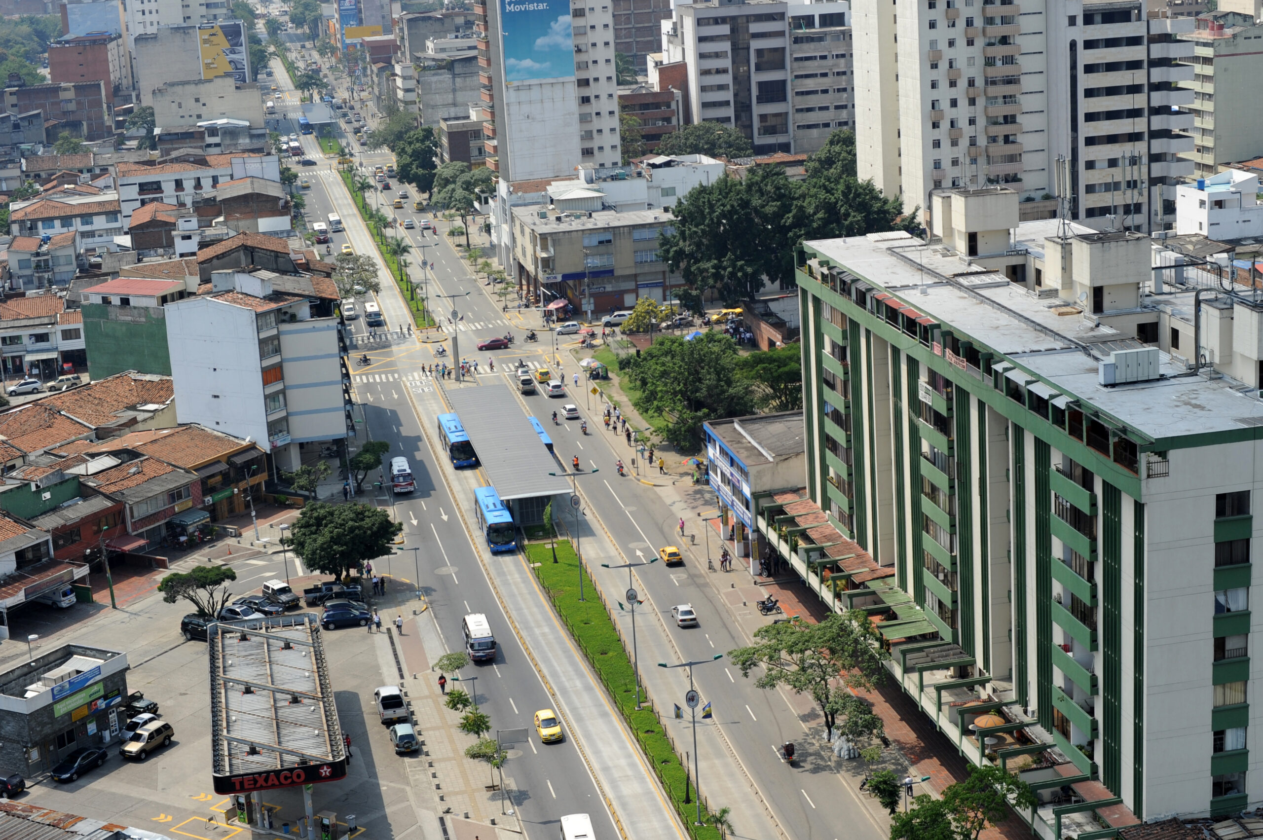 Foto desde el aire en la cual se ve la estación Américas, dos buses del MIO en ella y los dos carriles mixtos.